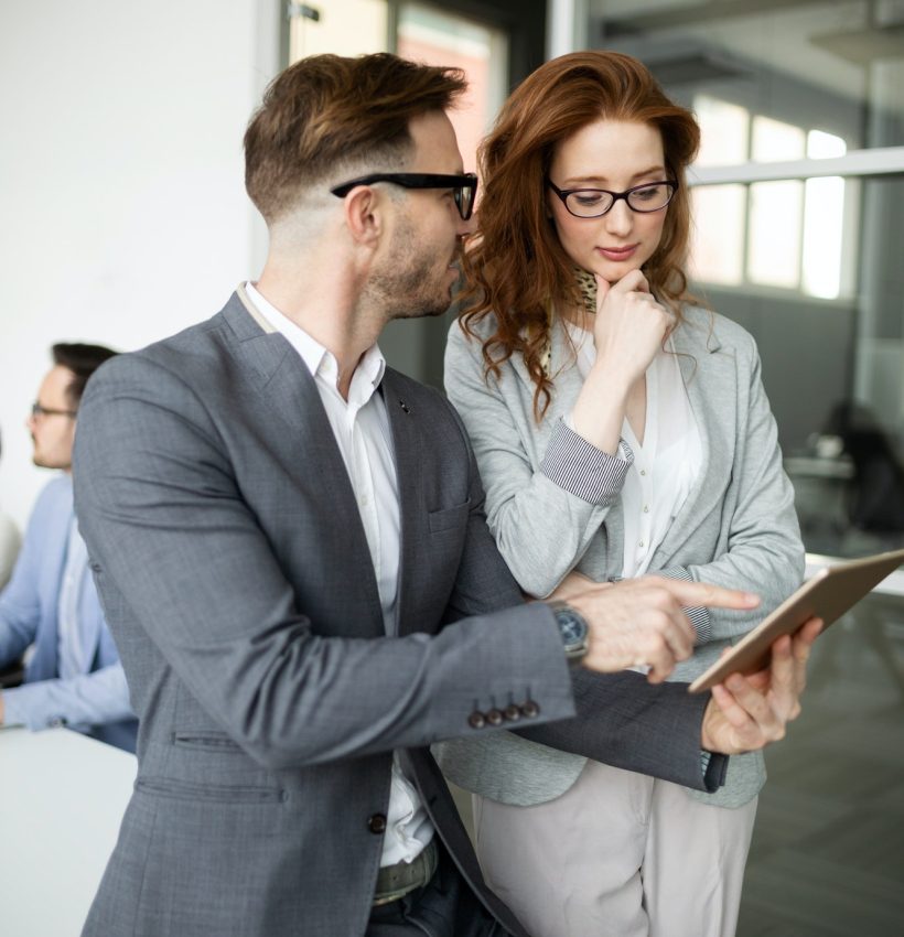 group-of-lawyers-discussing-contract-together-in-office.jpg